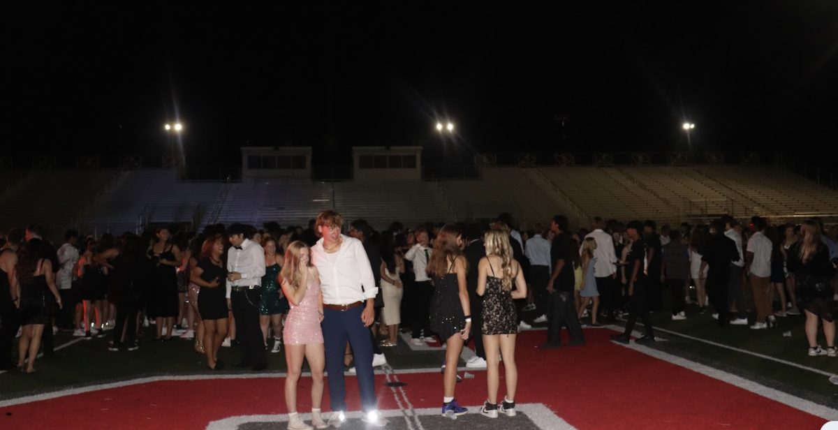 Students gather at the football stadium for a night full of dancing, food, and fireworks.