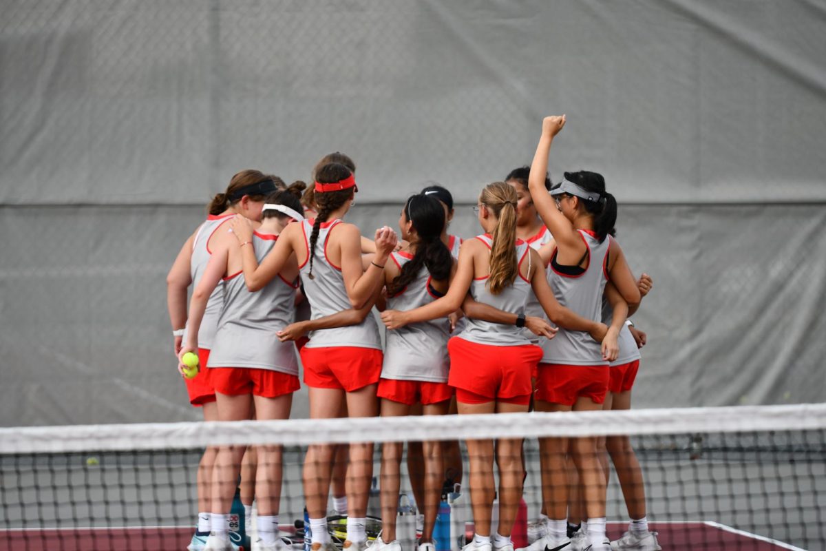 Palatine's Varsity Tennis team bundle up for a pep talk before playing 