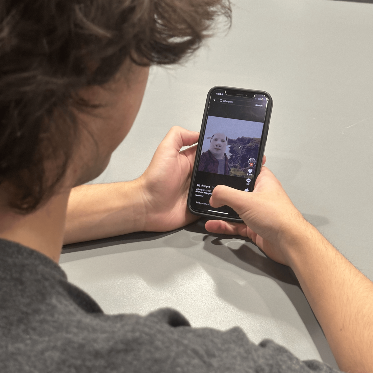 Cam Smith watches a TikTok video about John Pork, a popular internet meme of an anthromorphic pig that originated on TikTok.