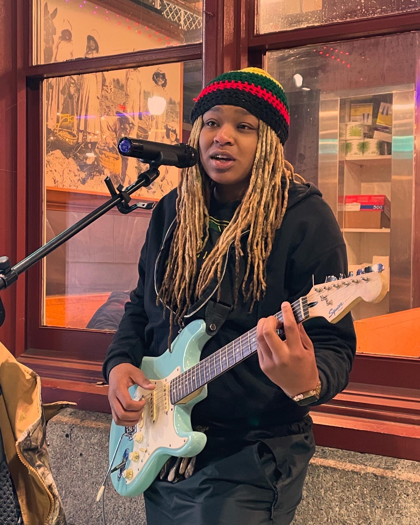 Philly artist BLCK performs outside the Reading Terminal Market.