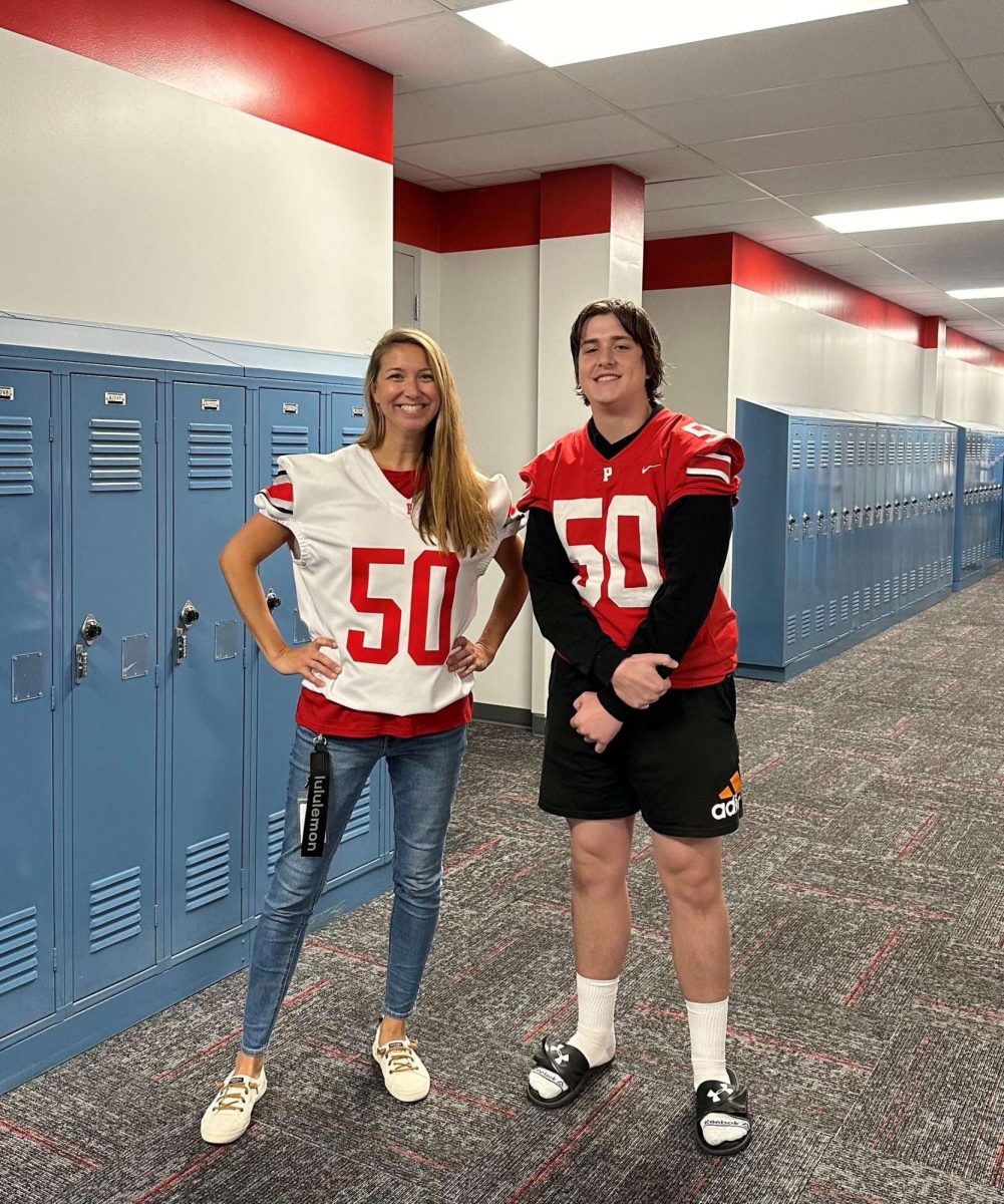 Ryan Meyers gives his jersey to social studies teacher Julie Van Grimbergen.