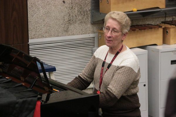 Ann Forman accompanies the choir students, her head nodding to the harmonization of student voices and piano keys.