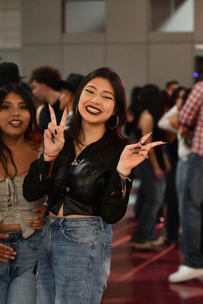 Denise Garcia poses for the camera in between dancing to catchy Latin American songs. Throughout the night, Garcia danced cumbias, a Colombian folk dance that focuses on musical rhythm.