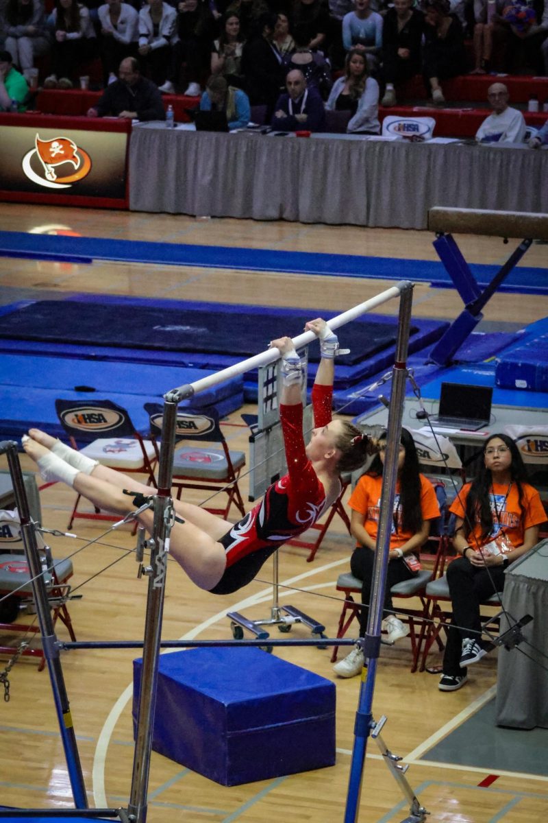 PHS Jolee Waddington (26) competes in Uneven Bars at 2025 IHSA State Finals Girls Gymnastics on Feb 22. Jolee scores a 9.375 and placed third for Uneven Bars.