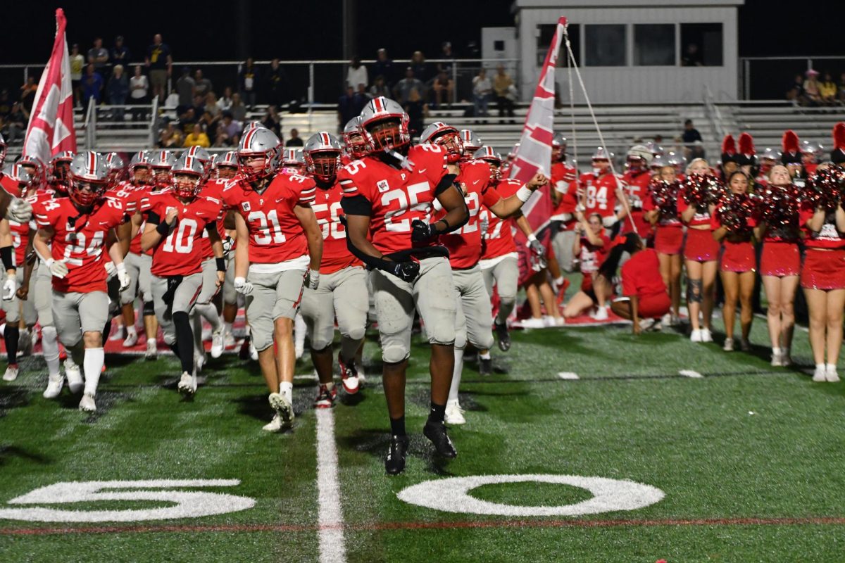 Palatine storms the field at the annual Red Out Homecoming game, bringing the energy under the Friday night lights
