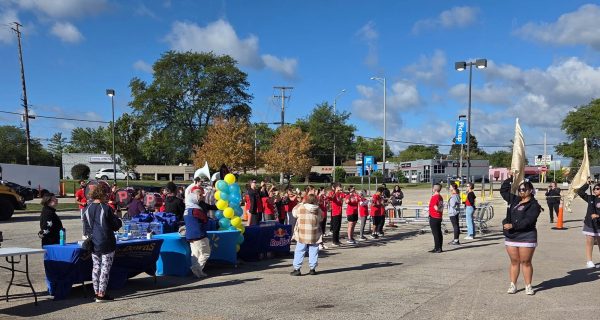 Palatine High School students from band and color guard perform in the parking lot of the Walmart on Rand Rd. 