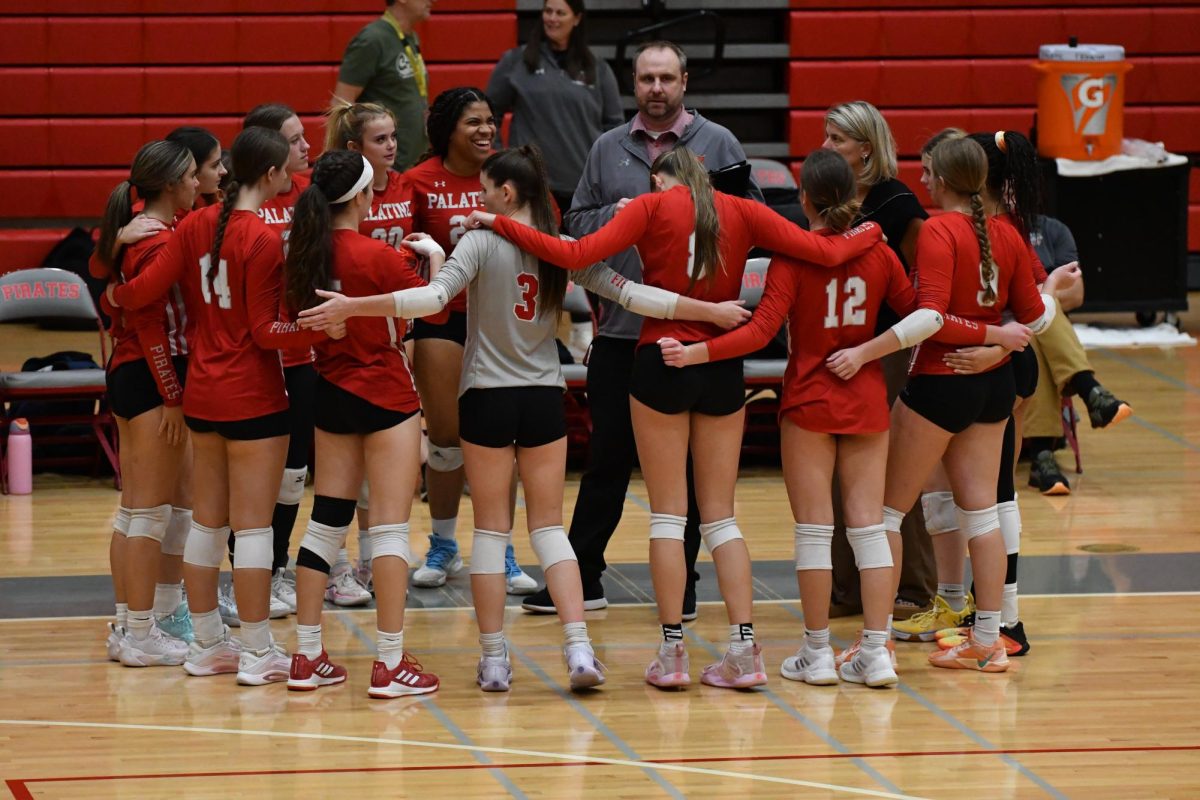 Varsity volleyball team meets to discuss the game against Schaumburg.