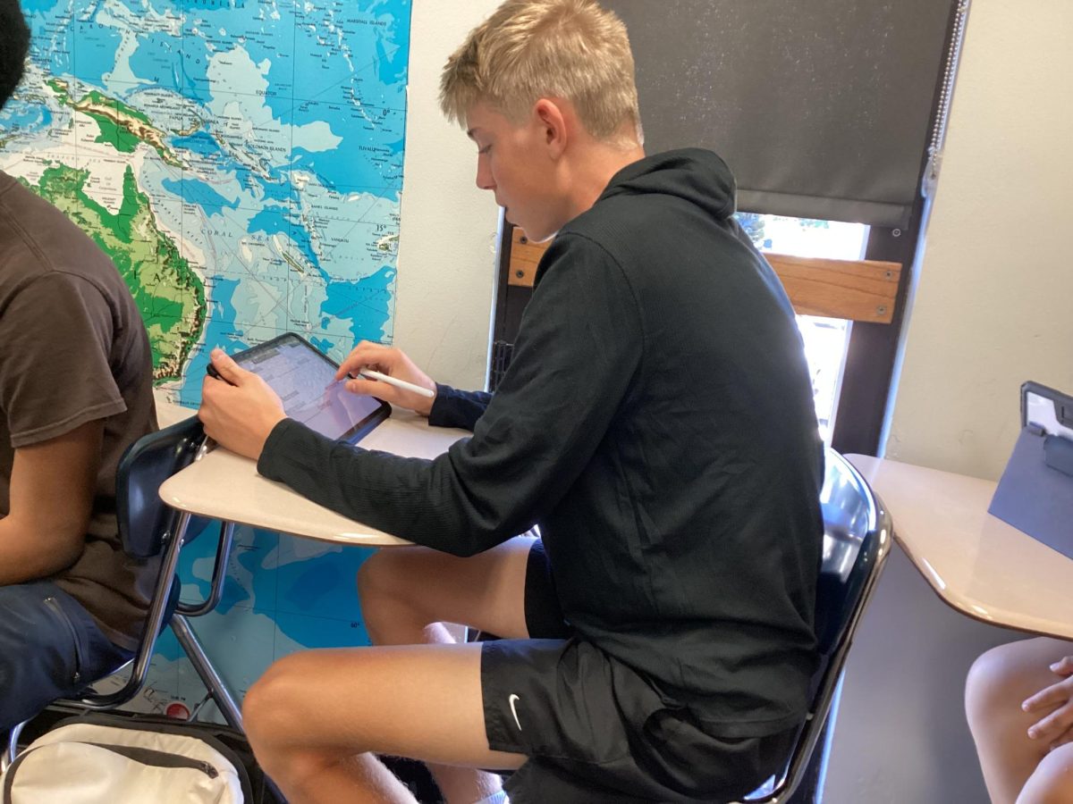 Connor Carro sits in a classroom during his second period Advance Placement Psychology class using his iPad to take notes.