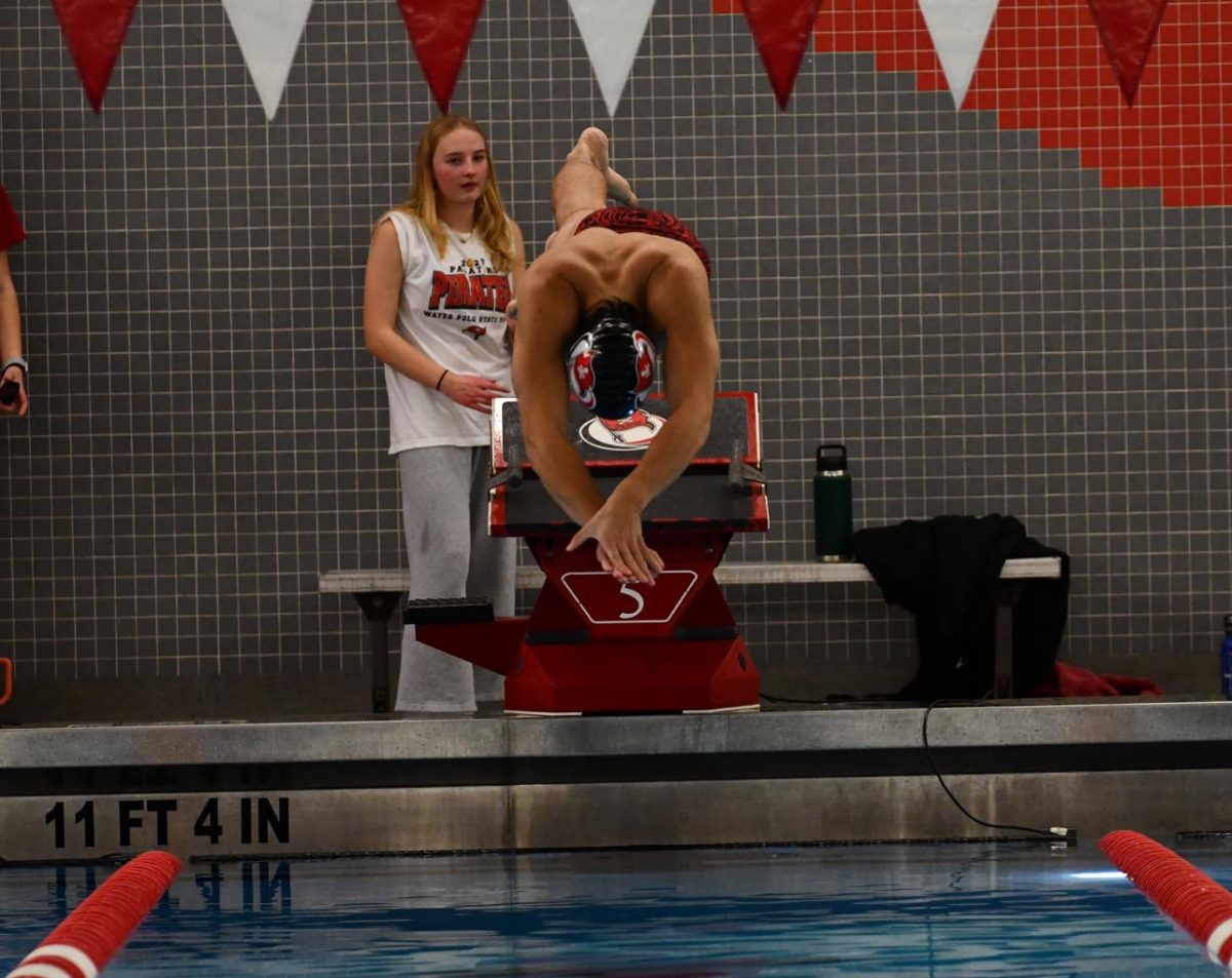 Senior Sam Piazza dives in to start the 200 IM in the home opener against Schaumburg.