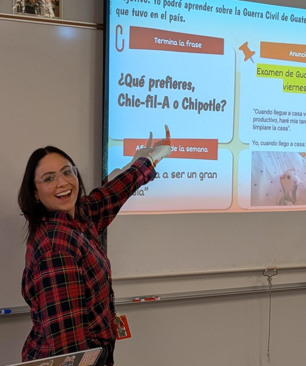 Spanish teacher Lizbeth Arreola enthusiastically points at a Spanish speaking prompt on her projector.
