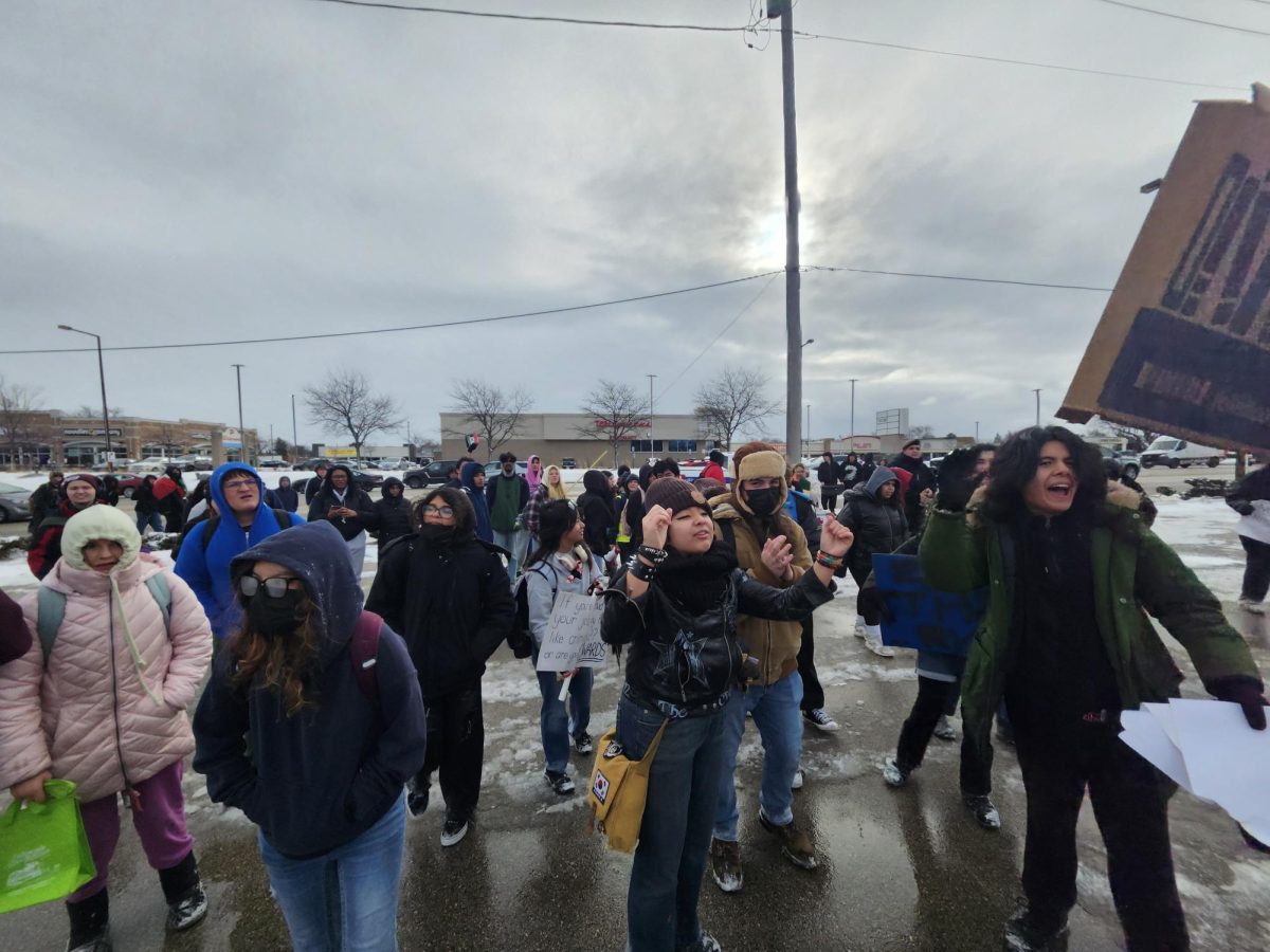 Students from across Township High School District 211 gather at the intersection of Dundee Road and Arlington Heights Road during a district-wide walkout protesting ICE raids on Jan. 14, 2026