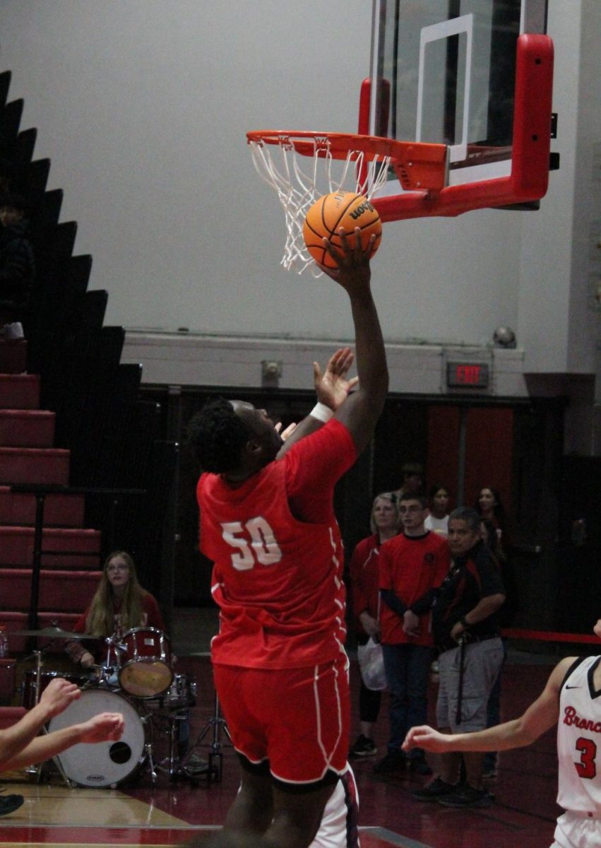 Senior Tony Balanganayi takes a layup in Jan 14 game against Barrington HIgh School.