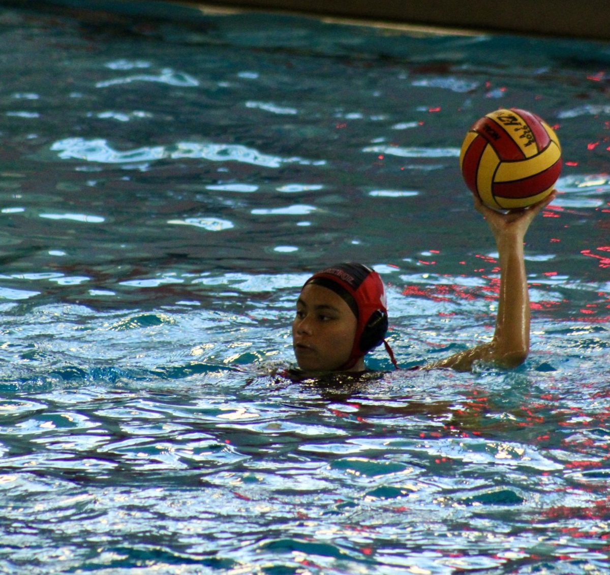 Junior goal keeper, Jaylnn Martinez holds the ball looking to pass it.