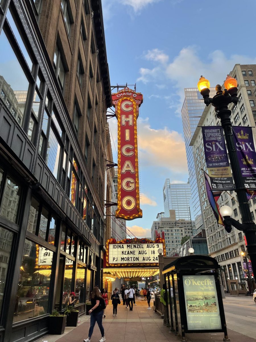 The iconic vertical sign of The Chicago Theatre, a historical landmark located on North State Street.