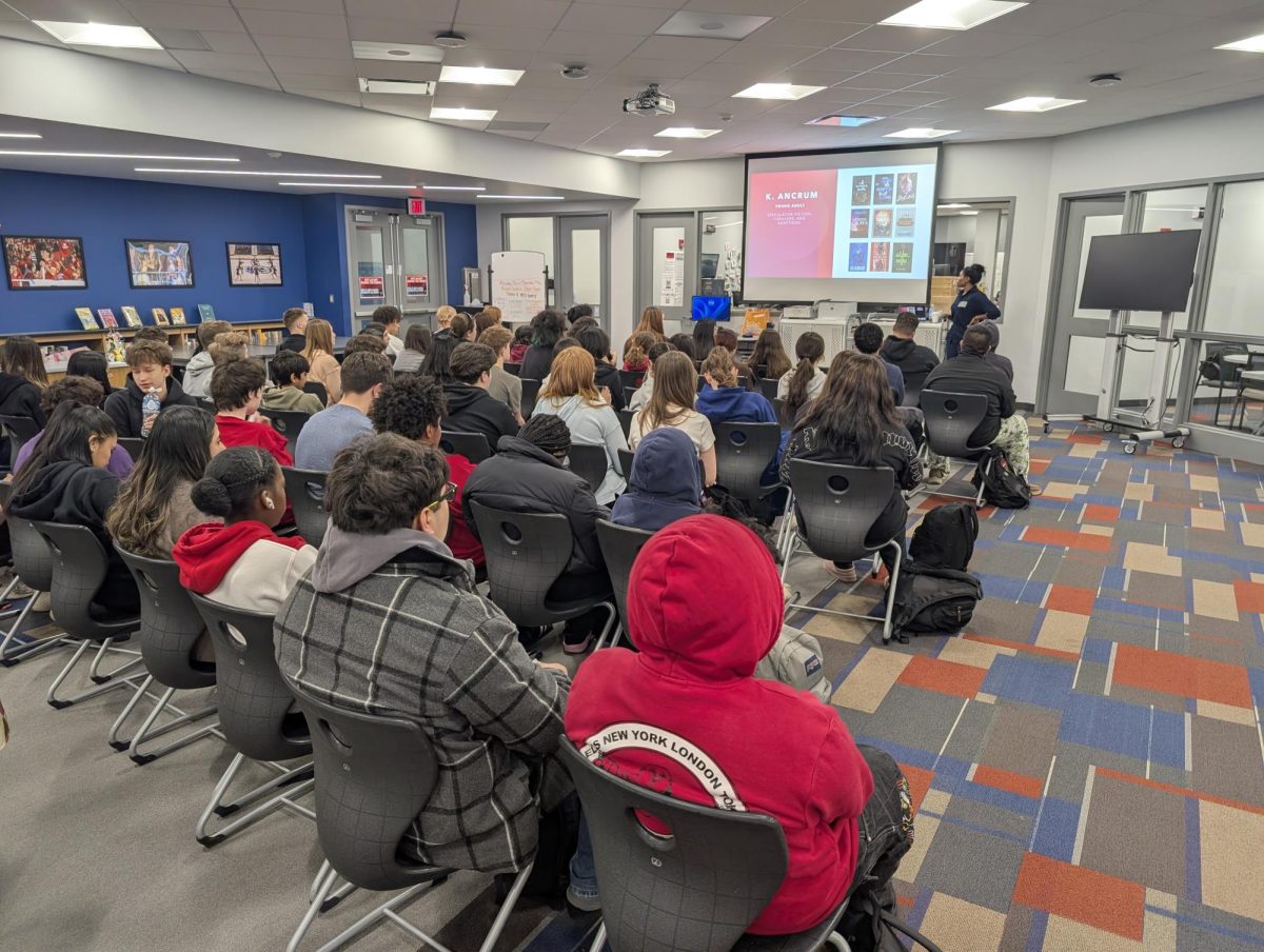 Author Kayla Ancrum leads an in-person workshop, sharing her journey and offering advice on becoming an author.